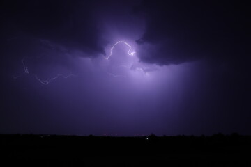 Fototapeta premium Lightning strikes at night during a severe thunderstorm