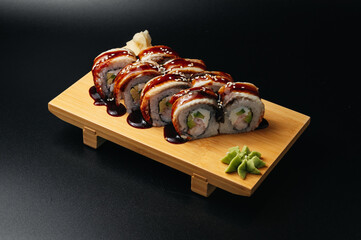 sushi roll with eel and shrimp on wooden board