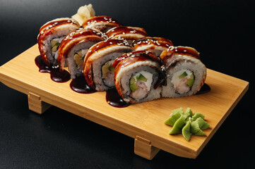 sushi roll with eel and shrimp on wooden board