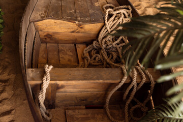 Close-up old wooden boat on the sand. Studio shot