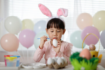 young girl making easter craft at home