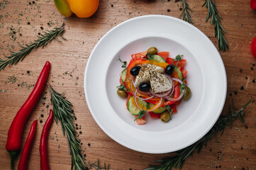 Close up of Greek salad with fresh vegetables, feta cheese and olives in a plate. Vegetarian healthy food diet
