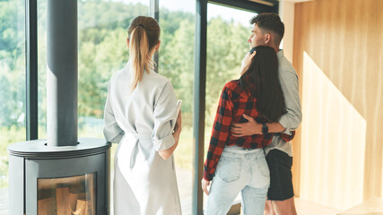 Back view of successful family couple meeting with woman realtor