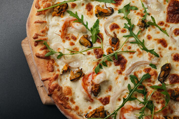 Delicious seafood pizza with arugula