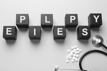 Flat lay composition with word Epilepsy on light grey background