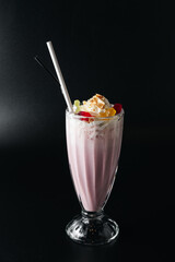 Closeup glass of milk shake isolated on black background