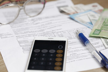 Receipt for payment. Community payments. On the table are glasses, a pen, a receipt, a calculator and money. Russian money.