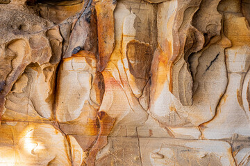 weathered and eroded sandstone rock on mountainside.