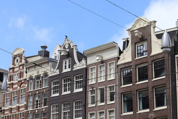 Fototapeta na wymiar Amsterdam Damrak Traditional House Facades with Various Gables