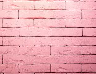 Brick wall is painted with pink paint. Abstract texture for background.