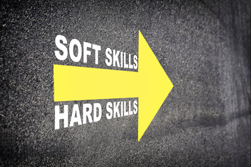Soft skills and hard skills words with yellow arrow marking on road surface. Business success with direction concept and intelligence emotional quotient idea