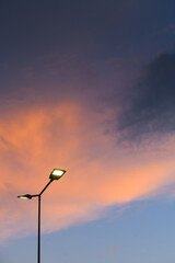 Public street lighting pole with LED lights with an amazing sunset color background.