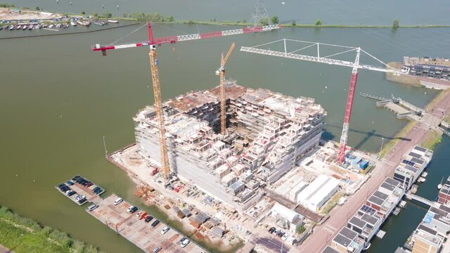 Hyperlapse of a construction site of an appartment residential building with cranes near Ijburg, Amsterdam The Netherlands. Holland.