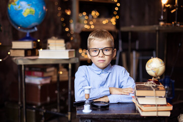 schoolboy puts on glasses. Back to school concept. A boy nerd in a  uniform. Primary School. Home...