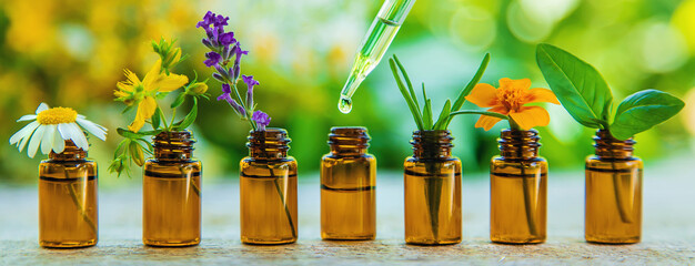 Essential oils and herbal extracts in small bottles. Selective focus.