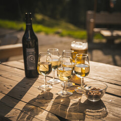 Obraz premium apero time with white wine and beer after a long hike