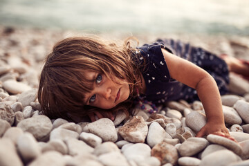 Cute little girl posing in front of a camera.