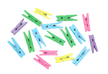 Many colorful wooden clothespins on white background, top view