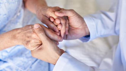 Hands of a senior woman hold for comfort and concern
