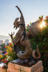 Statue of mythical Basilisk in Trsat castle overlooking Rijeka, Croatia. Outdoor travel background in sunset light