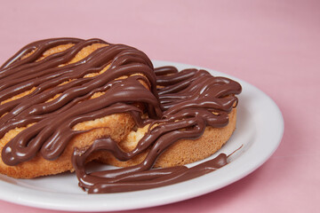 fresh pancake in a plate poured with chocolate paste, cream on buns, pancakes with chocolate
