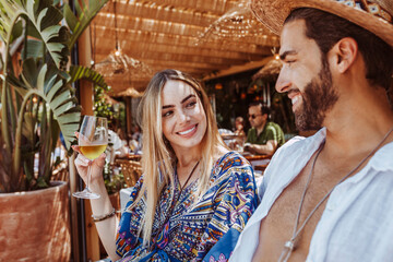 Couple in love drinking white wine in the summer