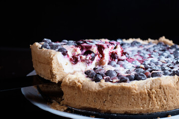 Berry pie cake from the cherries currants in a bowl of fresh steam a whole and slices of hot background blurred