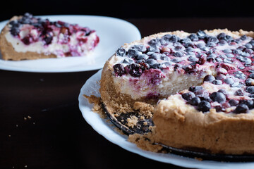 Berry pie cake from the cherries currants in a bowl of fresh steam a whole and slices of hot background blurred