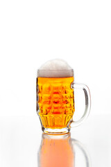 Mug of refreshing light beer close up on white background