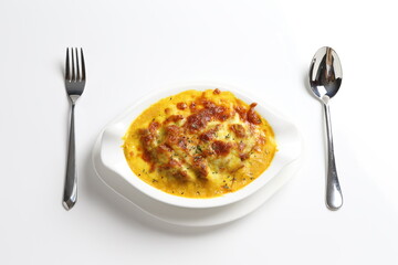 oven baked creamy cheese Japanese curry pasta with chicken in bowl western chef cuisine seafood menu in white and brown background