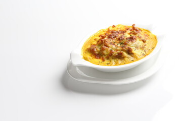oven baked creamy cheese Japanese curry pasta with chicken in bowl western chef cuisine seafood menu in white and brown background