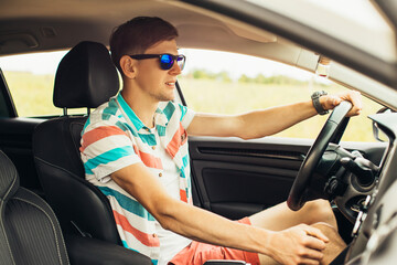 Obraz premium Young man driving his car, happy man driving a car, concept of vacation, trip, travel