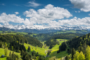 Obraz premium view over Trub with hills and forests of Emmental towards the bernese alps