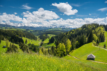 view over Trub with hills and forests of Emmental towards the bernese alps