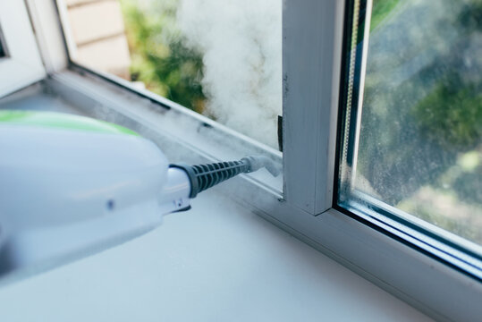 The cleaning device blows a jet of steam into the window frame to remove dirt