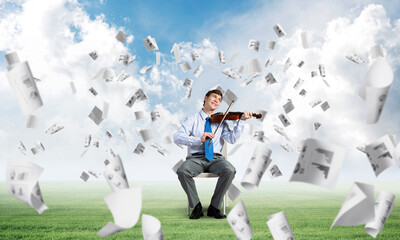 young businessman playing violin