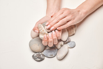 Woman hands with beautiful manicure on light background