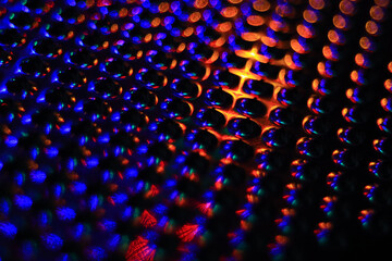 Red and blue reflection on a metallic surface
