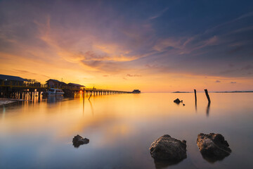 Amazing sunrise in the fishing village of Sembulang beach, Batam island
