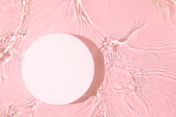 Empty white circle podium on transparent clear pink calm water texture with splashes and waves in...