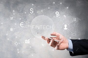 Obraz premium Businessman hold Fintech -financial technology concept.Business investment banking payment. Cryptocurrency investment and digital money. Business concept on virtual screen.