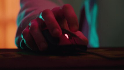 Shot of hands man gamer playing in the computer. Using mouse and keyboard in the evening. Cybersport, young, streaming. Close up. Slow motion