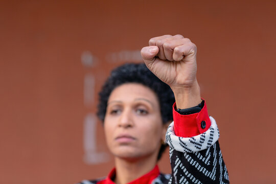 Italy, Tuscany, Pistoia, Woman Raising Fist