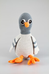 A knit toy doll dove isolated on grey background