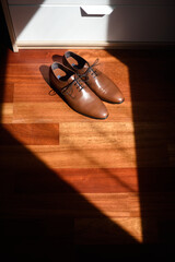 Pair of elegant shoes in the bedroom with window light