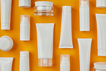 Lotion or cream set on orange background. Care products skincare routine - obrazy, fototapety, plakaty