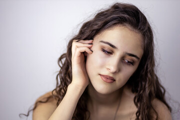 Portrait of a teen brunette girl daydreaming