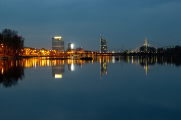 Night view of the city Riga, Latvia. Blue night photo to the city of Riga when building reflecting in the water of Daugava river.