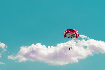Marmaris, Mugla, Turkey: 06,09,2021 - Parasailing with I Love Turkey slogan , a couple doing watersports in Turkey , blue sky and cloud background