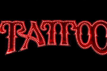 Glowing tattoo sign in black background